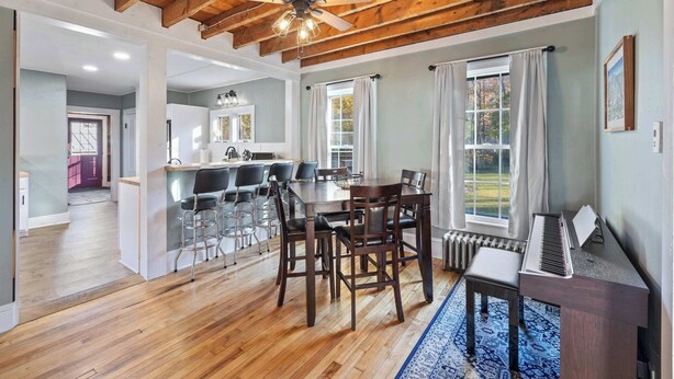 A spacious dining area with a wooden ceiling, a piano, and a view of the outdoors. - Serene 4-BR Farmhouse 5 min to Okemo (Ludlow)