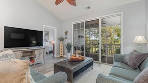 A living room with a flat-screen TV, a coffee table, and a sofa. - Ironwood 1634 - Stunning Corner Unit! (North Myrtle Beach)