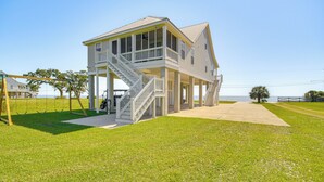 A two-story house with a balcony and a staircase leading to the second floor.