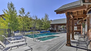 A pool area with lounge chairs and a wooden pavilion. - Downtown WP Condo w/ Pool: Steps to Concert Venue! (Winter Park)
