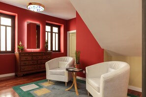 A room with two white armchairs, a wooden dresser, and a small table with a plant. - Dream Vacation at Casa Vicki (Almeria)