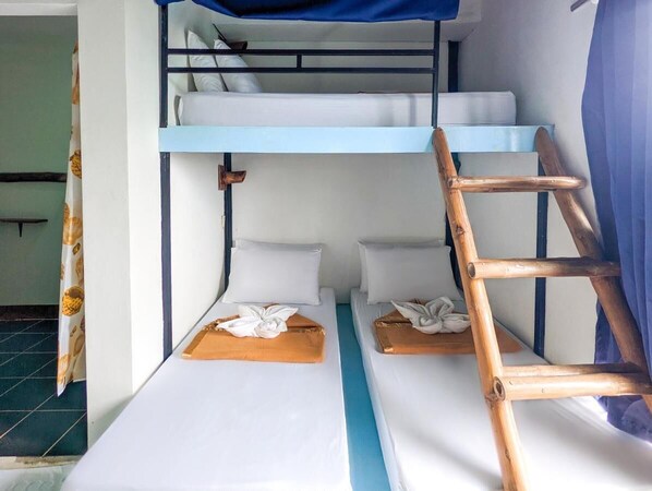 A bunk bed room with a wooden ladder, white bedding, and a blue canopy. - Lexias Hostel & Workspace by Hiverooms (El Nido)