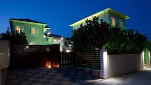 A gated residential area with two houses, a checkered driveway, and a lantern on the gate. - Stunning 2-bed House in Lefkas (Lefkada)