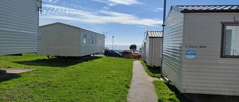 A row of mobile homes with a paved walkway between them.