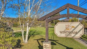 A golf club sign with a logo, surrounded by trees and a clear sky. - Cozy Mtn-View Chalet < 2 Mi to Windham Slopes (Windham)
