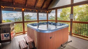 Una terraza de madera con un jacuzzi, bancos de madera y un cofre de madera con la etiqueta 'Tecate Light'.