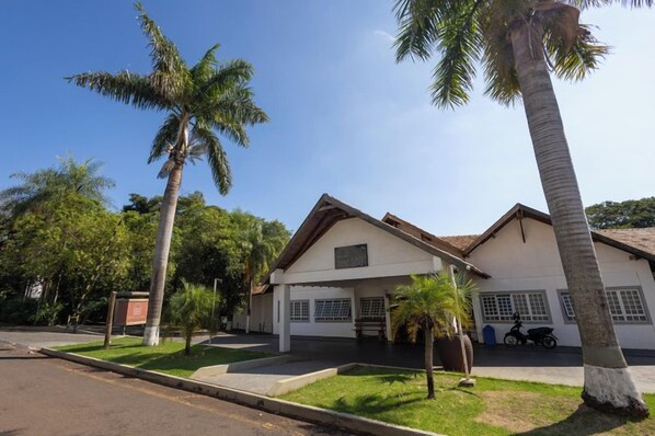 A two-story building with a flat roof and a front porch.