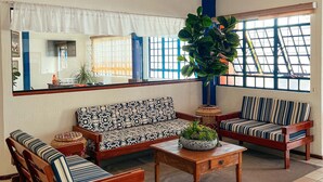 A living room with two sofas, a coffee table, and a ceiling fan.
