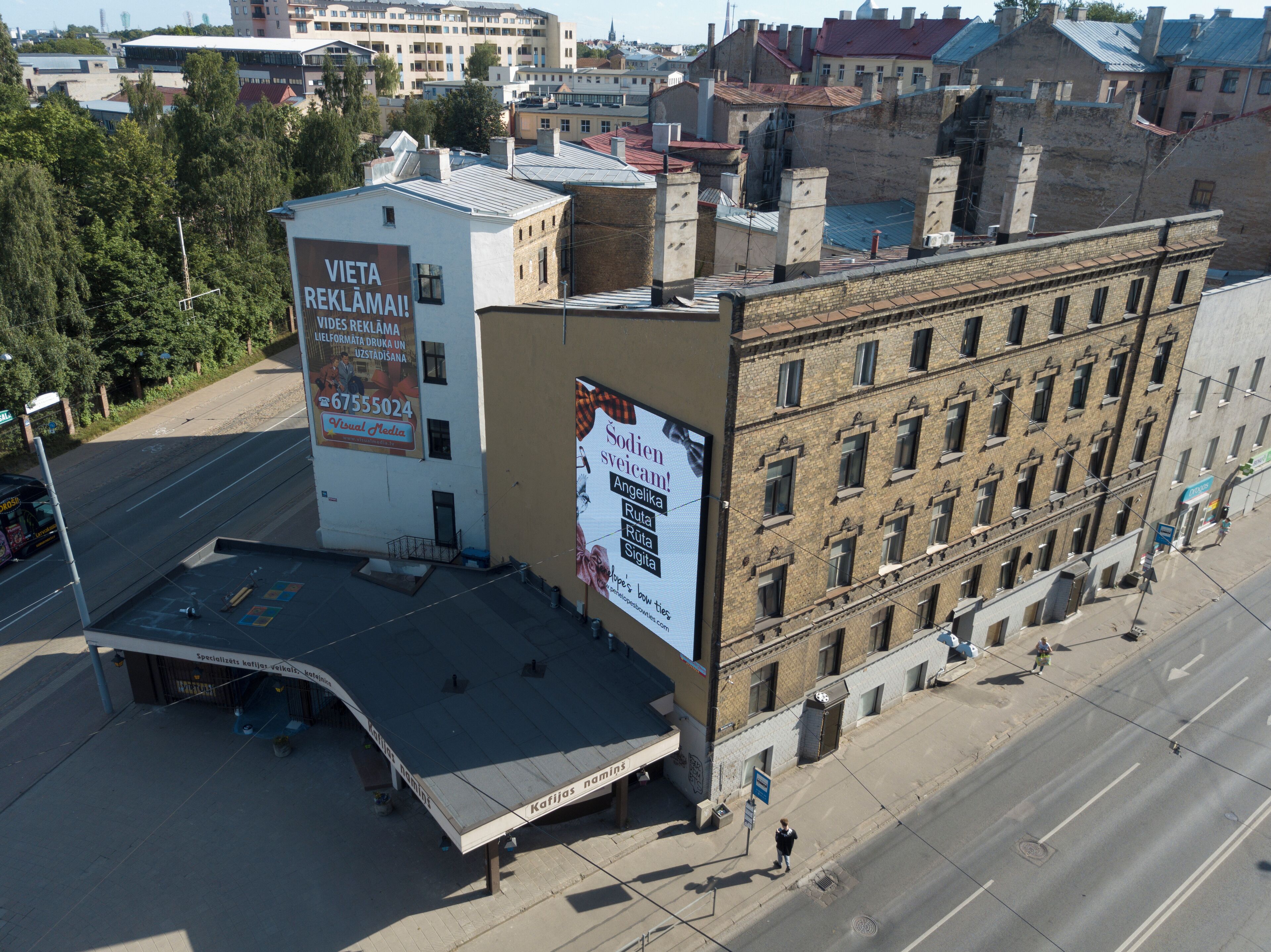 A building with a large billboard advertising a product.