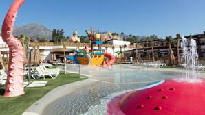 A water park with a large octopus sculpture, a colorful boat ride, and a fountain. - Magic Pirates Island Resort (Benidorm)