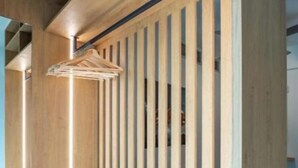 A wooden interior with built-in shelves and a hanging light fixture. - Athens Riviera Aelia Luxury Suite By the Sea - Location: Vouliagmeni, Kavouri  (Vouliagmeni)