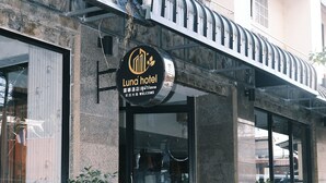 A hotel entrance with a sign reading "Luna hotel," a staircase leading up to the entrance, and potted plants around the area. - Collection O Luna Hotel Pattaya (Pattaya)