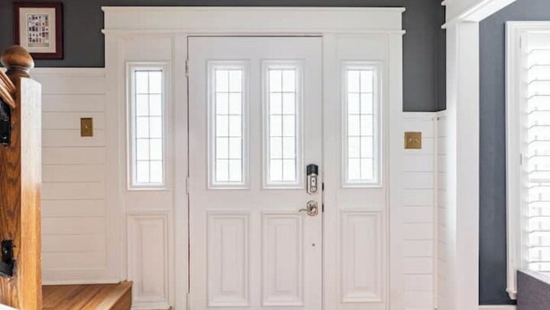 A white door with three windows, a wooden staircase, and a dark wall. - Tranquil Family Retreat in NW Austin, Hot Tub, Office, & Backyard Escape (Austin)