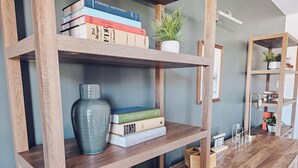 A wooden bookshelf with books and decorative items.