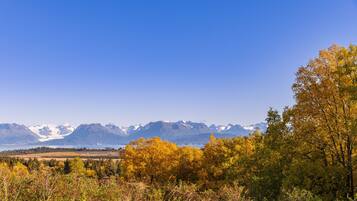 A mountainous landscape with autumn foliage and a clear sky.