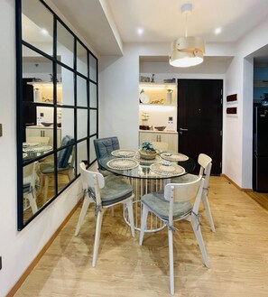 Enjoy meals in this stylish dining area with a round table and comfortable seating.