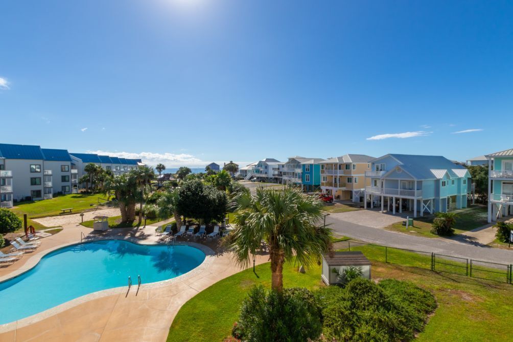 Un resort con piscina, varias edificaciones y cielo despejado.