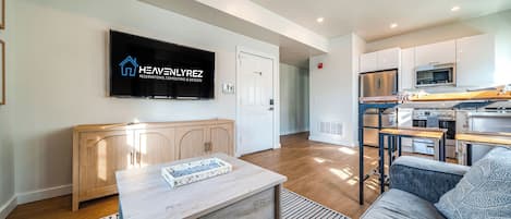 Modern living room with a flat-screen TV and sleek furniture