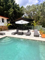 Outdoor pool, open 9:00 AM to 9:00 PM, pool umbrellas, pool loungers