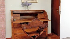 A wooden desk with drawers and a curved front, a framed picture on the wall, and a door to the right. - Anno Domini Appia Antica 120 sqm, large,  elegant, close to the historic center (Roma)
