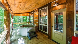 A wooden cabin with a hot tub, large windows, and a deck. - EvergreenGrove-2 cabins/4BR (Oakland)