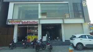 A modern building with a large glass facade and a sign reading "CHINTU". - Wishotel Xpress Hotel GK Inn  (Dewas)