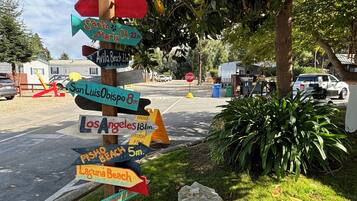 A wooden signpost with directional arrows pointing to various destinations.