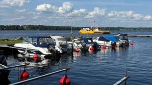 A marina with several boats docked, a yellow ferry in the background, and calm water. - 3 bedroom gorgeous home in Ljungby (Ljungby)