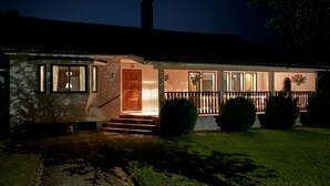 A two-story house with a brick facade, a wooden front door, and a small porch with a railing. - 3 bedroom gorgeous home in Ljungby (Ljungby)