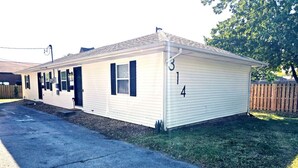 A single-story mobile home with a garage, numbered 314, featuring a simple, functional design with a flat roof and minimal exterior features.