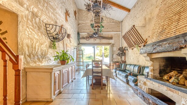 A spacious interior with a kitchen, dining area, and living room. - Holiday Home 'La Grange' with Private Pool, Private Terrace and Wi-Fi (Guizengeard)