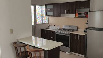 Fridge, oven, coffee/tea maker, cookware/dishes/utensils