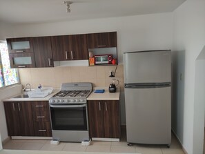 Fridge, oven, coffee/tea maker, cookware/dishes/utensils