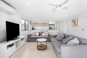 Relax in this stylish living room with a sofa, flat-screen TV, and coffee table.