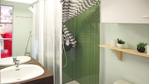 A bathroom with a shower, a sink, and a toilet. There are plants on a shelf and a mirror above the sink. - Mini studio 2 persons located in the residence le belvédère (LES ORRES 1650)