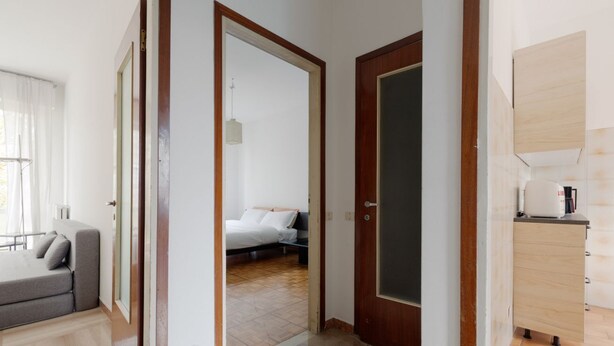 A hotel room with a bed, a sofa, a desk, and a bathroom visible through an open door. - Functional apartment of about 54 square meters, able to accommodate up to 4 people, located on the top or floor of a building with a lift.The property is located in a historic area of the Navigli near the Milanese nightlife, full of restaurants, ba (Milano)