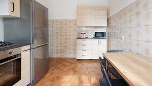 A compact kitchen with a stainless steel refrigerator, a microwave, and a stove. - Functional apartment of about 54 square meters, able to accommodate up to 4 people, located on the top or floor of a building with a lift.The property is located in a historic area of the Navigli near the Milanese nightlife, full of restaurants, ba (Milano)