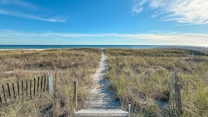 A wooden boardwalk leading to a beach with a clear sky. - Sunkissed Sands @ Perdido Dunes | Spacious & Beachfront | Direct Beach Access | My Beach Getaways (Pensacola)