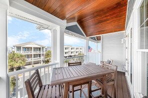 Enjoy dining al fresco in this sheltered outdoor space with a table and chairs.