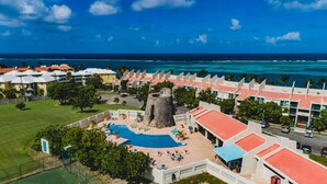 A resort with a swimming pool, a stone tower, and ocean views. - Stunning Caribbean Sea views! (Christiansted)