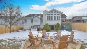 A backyard with a fire pit and outdoor seating. - Spacious 5-bedroom House, Hot Tub, Firepit, Game Rooms, Theater Room and More! (Decatur)