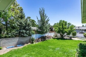 Enjoy a serene outdoor space surrounded by lush trees and a well-manicured lawn.