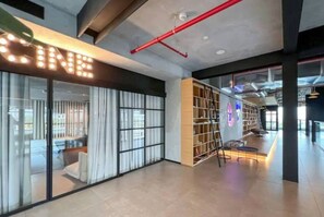 Experience the perfect blend of relaxation and entertainment in this stylish space, featuring a cinema area, cozy reading nook, and inviting staircase.