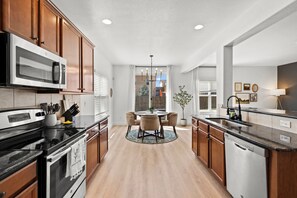 Fridge, microwave, oven, stovetop - Modern 5BR Home Near Airport - Central Location & Hot Tub (Colorado Springs)