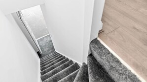 A staircase with carpeted steps leading to a landing. - Apartment 1 Bedroom,Sleeps6,Parking (Birmingham)