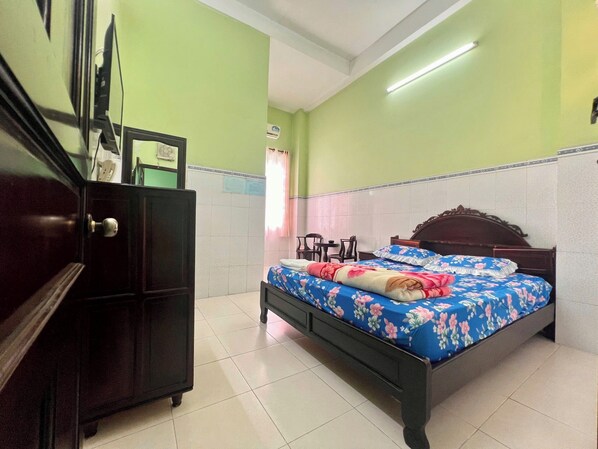 Una habitación con una cama, un armario y un escritorio.