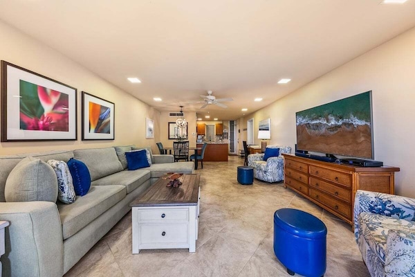 Open living area highlighted by an oversized L-shaped sleeper sofa for family and friends lounging