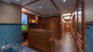A spacious bathroom with a large bathtub, wooden cabinetry, and a view of the outdoors. - Stay Passport Express Spa Dangsan (Seoul)