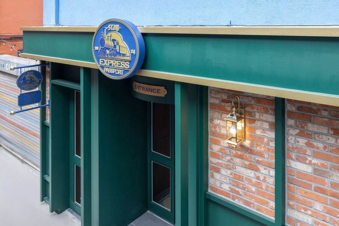 A building entrance with a sign reading "EXPRESS PASSPORT" and a "ENTRANCE" sign.
