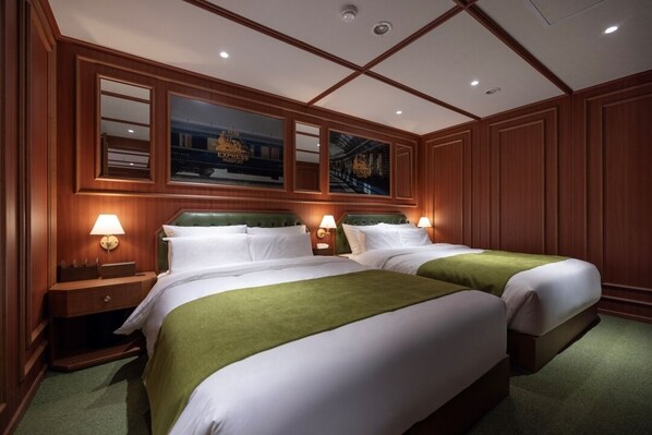 A hotel room with two beds, wooden paneling, and a large window with a view of a train. - Stay Passport Express Spa Dangsan (Seoul)